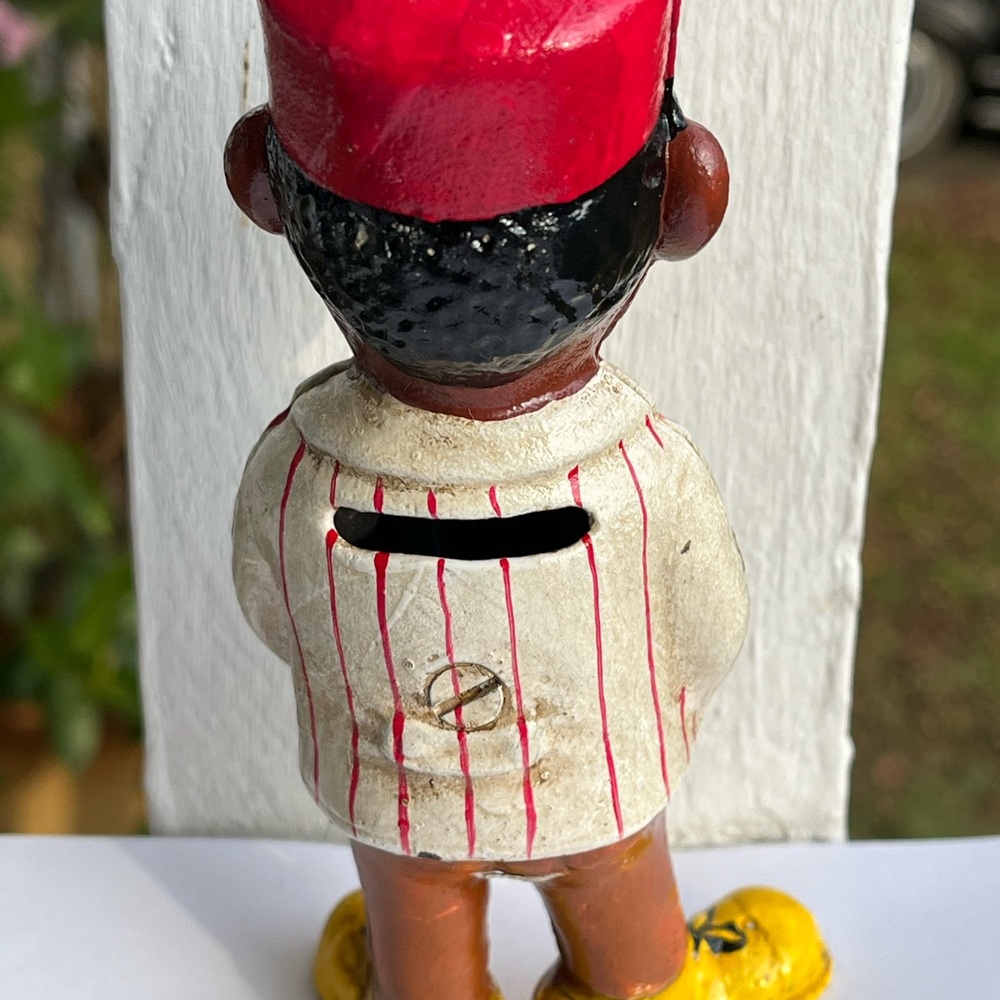 Vintage Cast Iron Coin Bank Taxi Man with Red Hat Striped Shirt Yellow Shoes